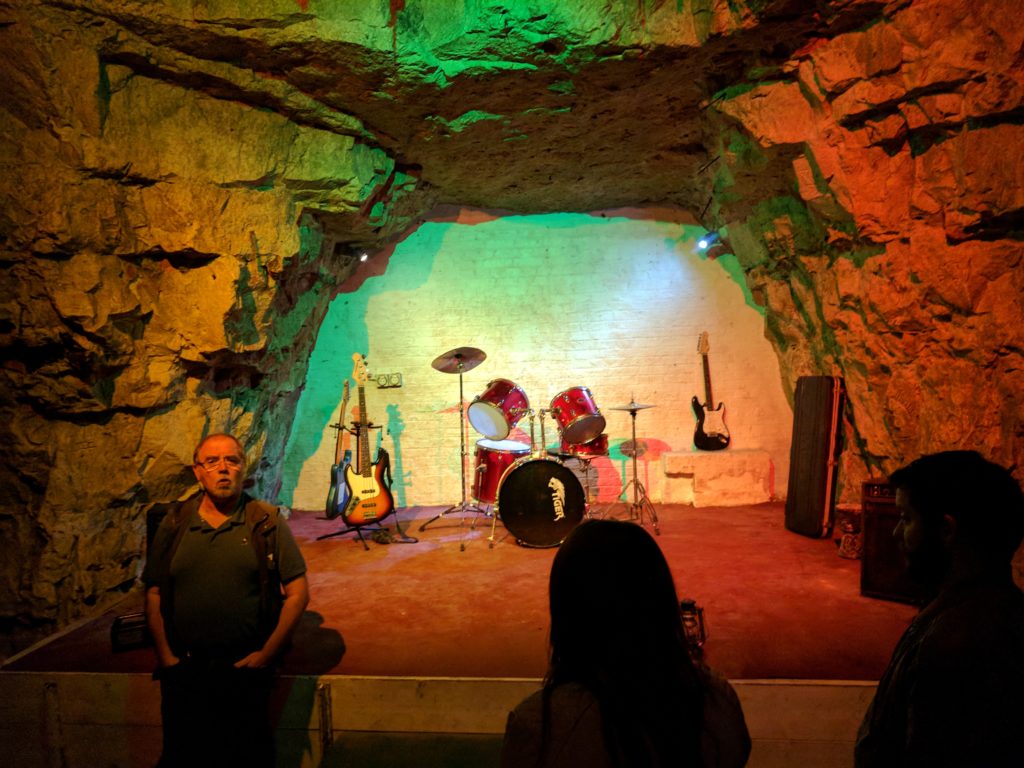 These mines served as bomb-shelter for Londonners. They needed a place to have entertainment, and this was it. The Beatles played on this tiny, multicolored stage, among many other famous bands.