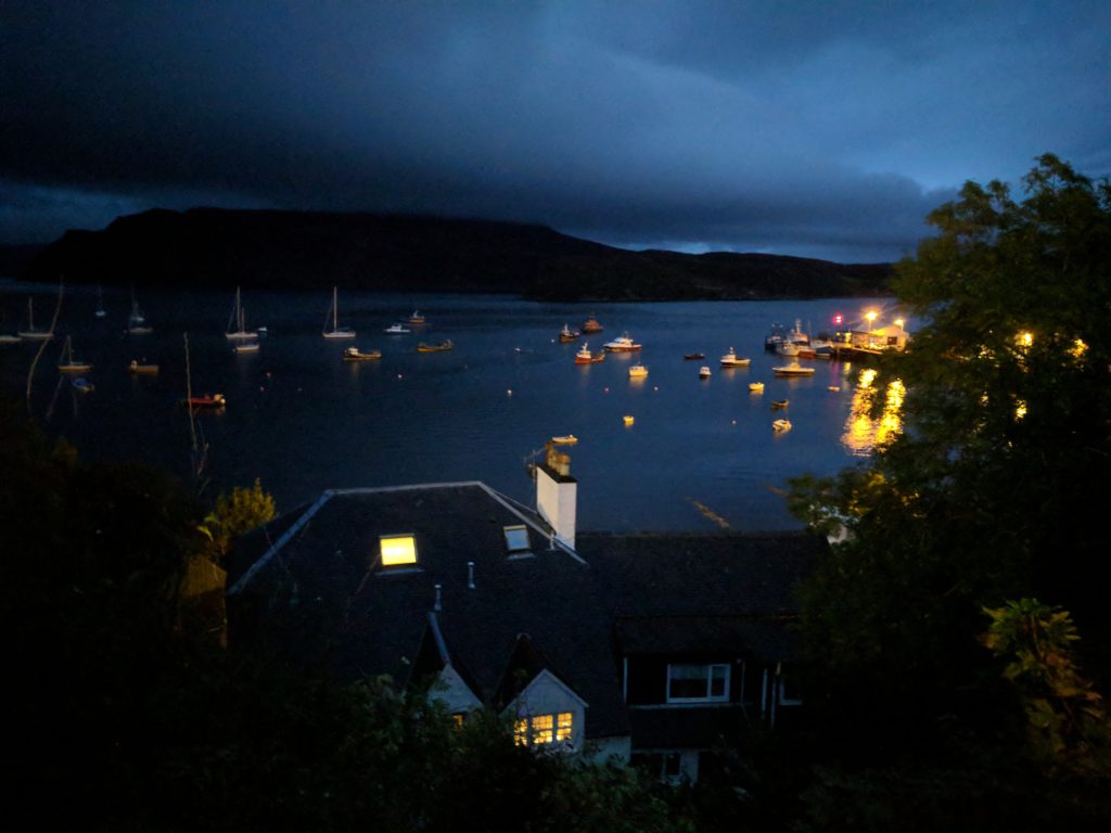 Portree's Harbour at night, from a main street that curls around the town