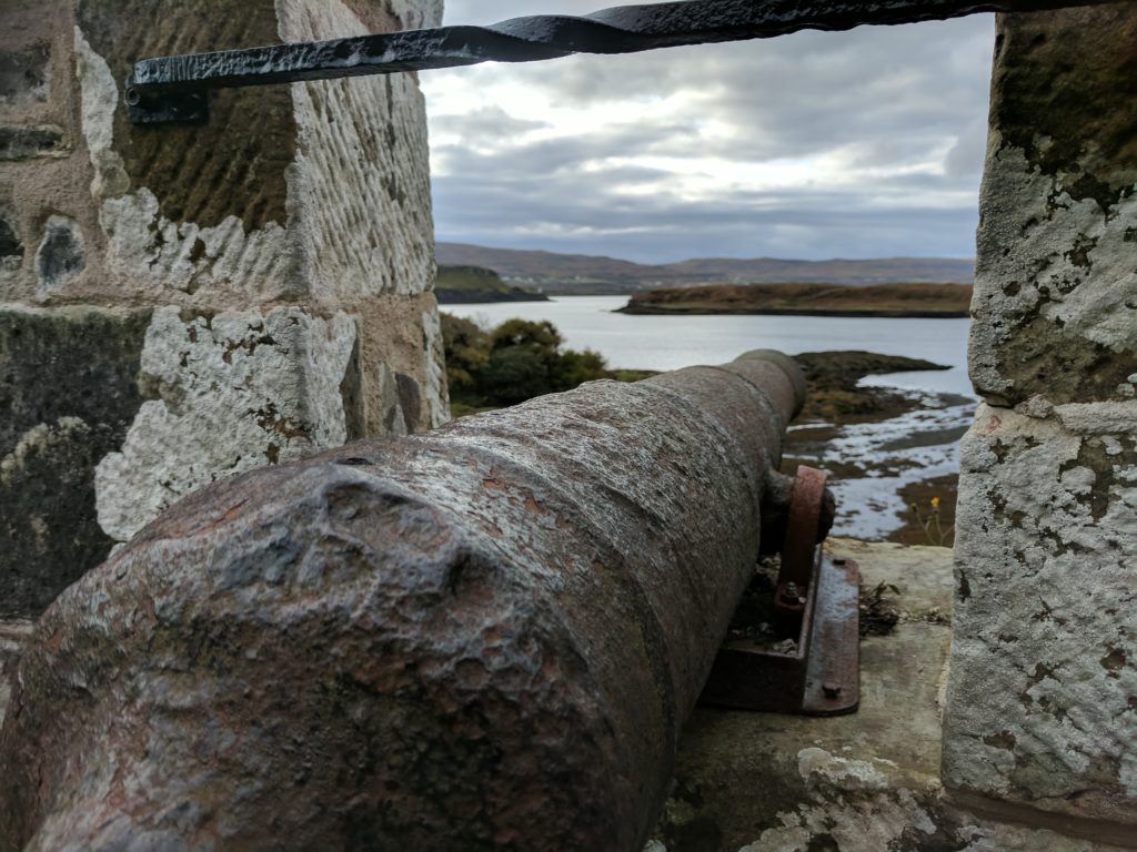 A cannon looking out towards the water at Dunvegan Castle