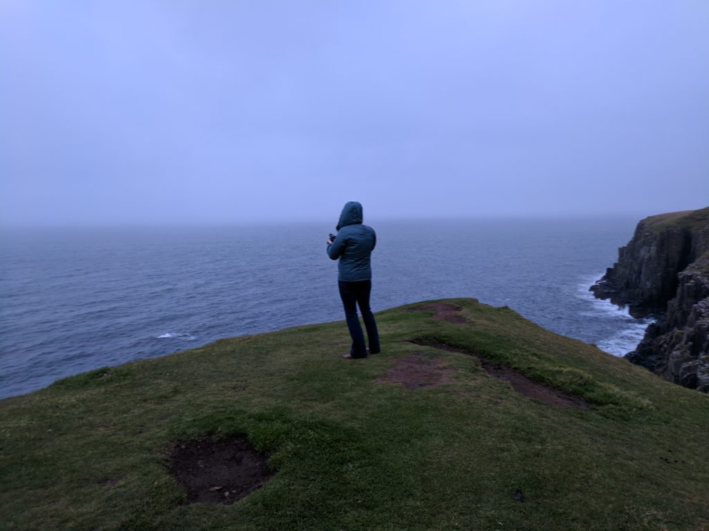 Sarah looks towards the barren ocean at Neist Point